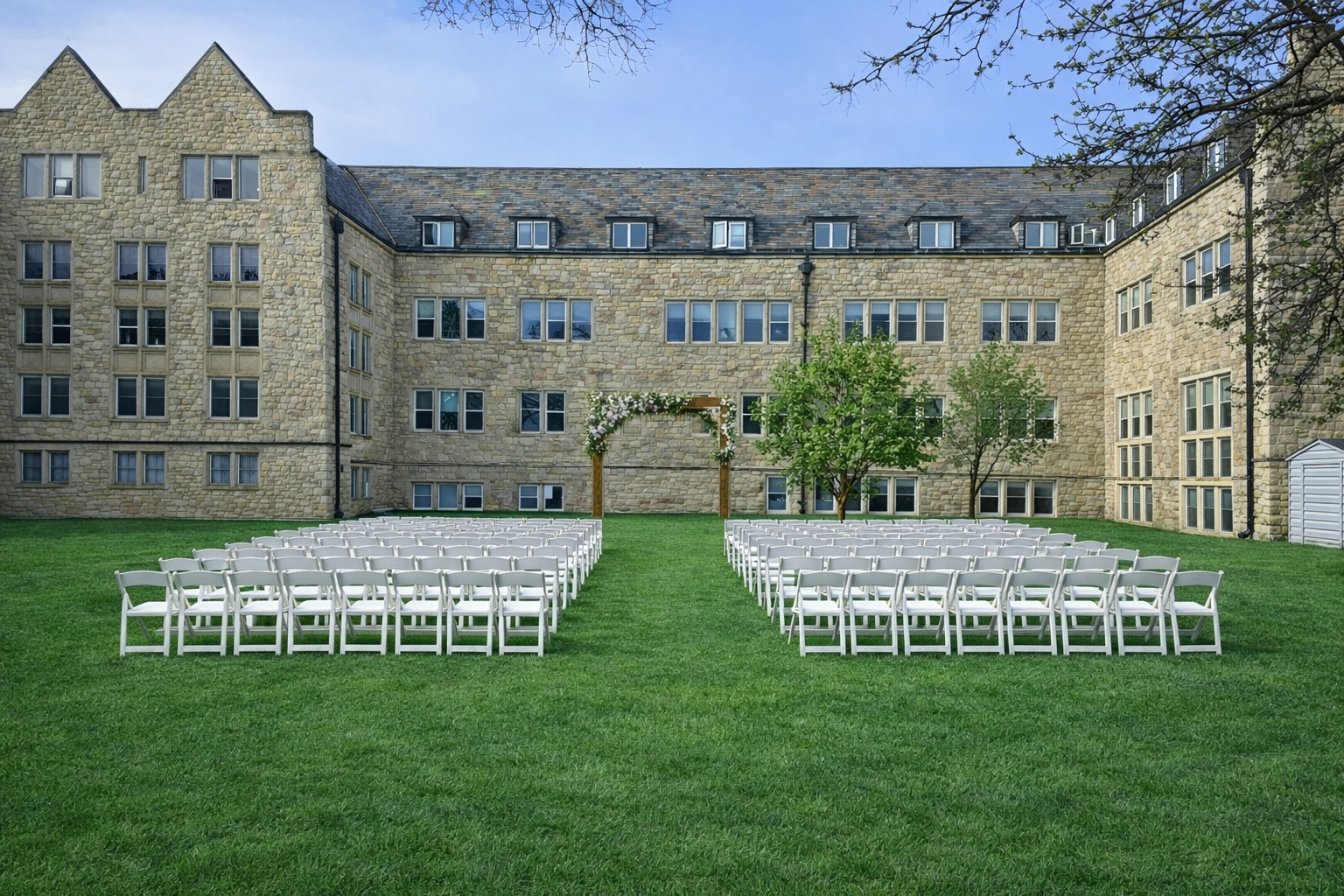 Outdoor wedding ceremony with floral arch and cross-back chairs. Altered with AI to demonstrate chairs & arch