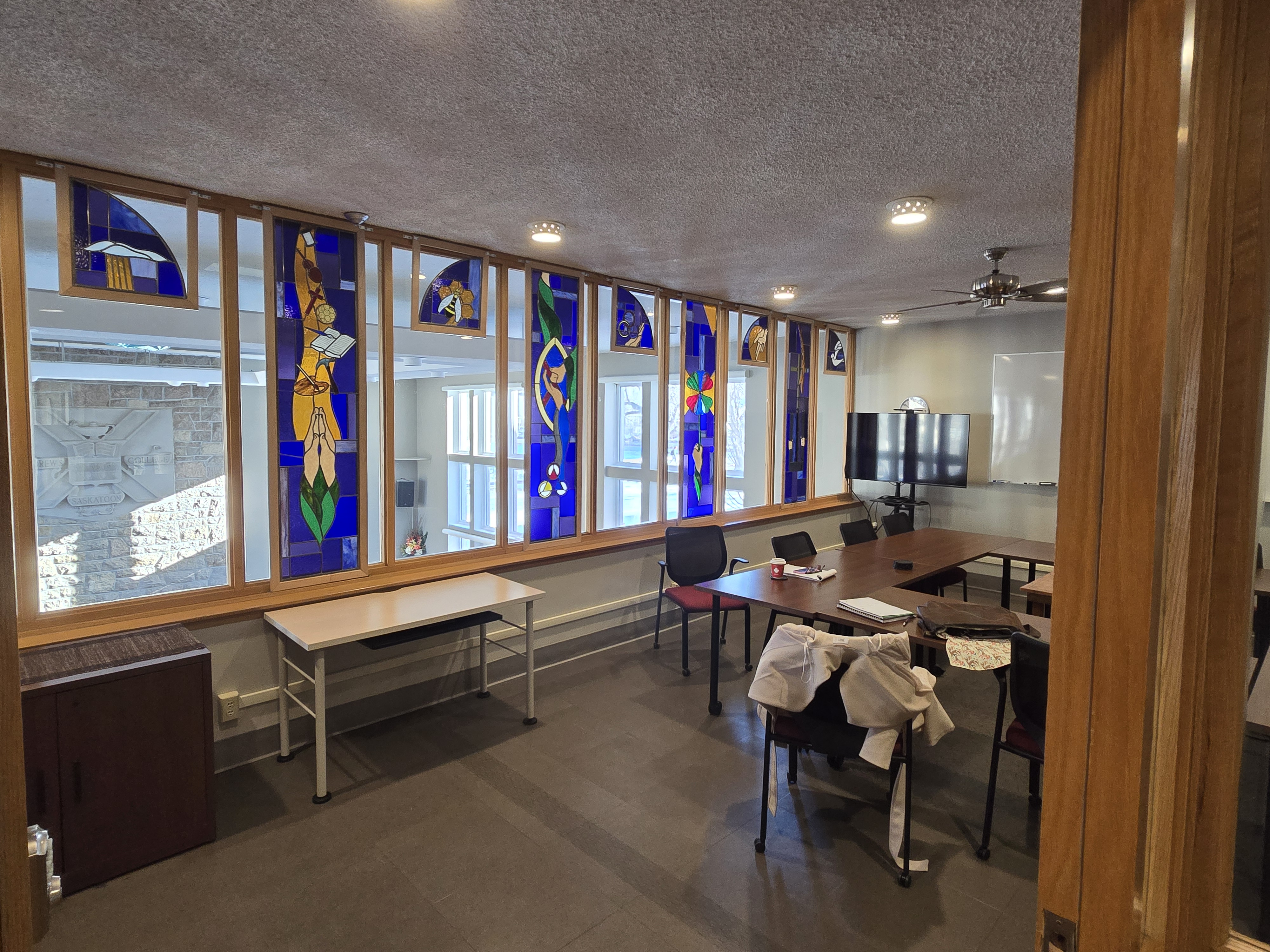 Classroom — long tables with chairs, stained glass windows