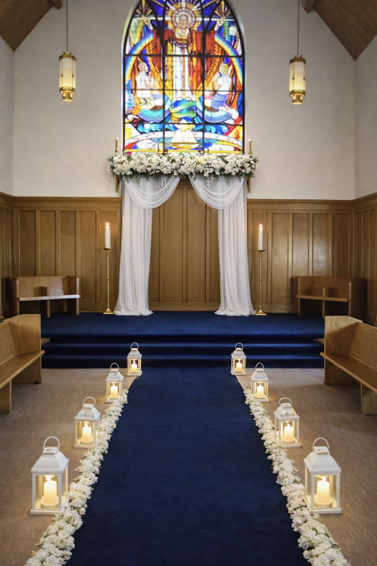 Chapel with wooden pews and floral arch